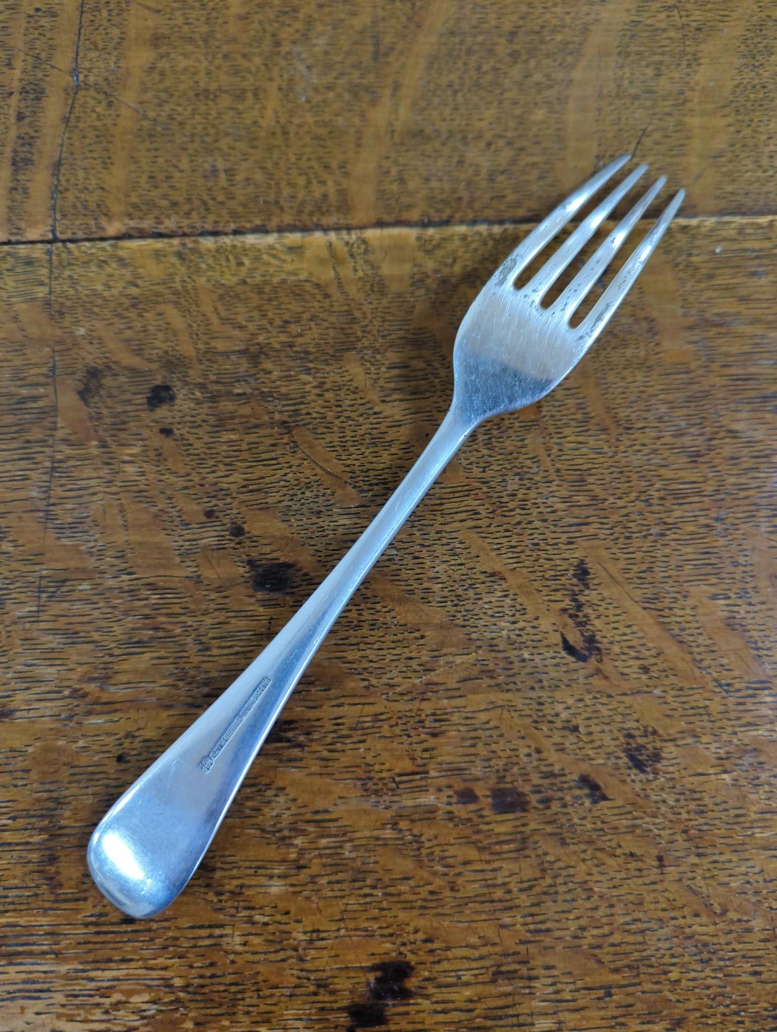 An Edwardian oak cased silver plated table canteen, settings for twelve and a set of silver plated fish knives and forks for twelve